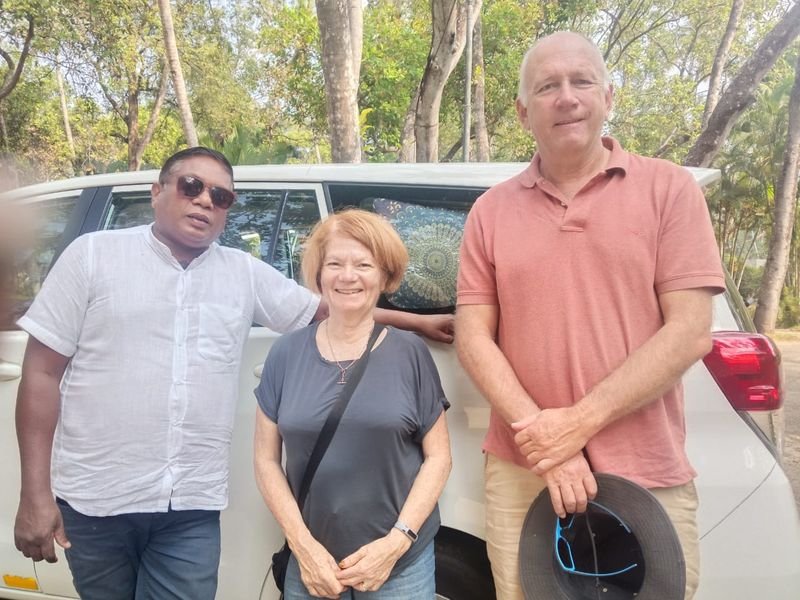 Car driver with foreigners with car nearby