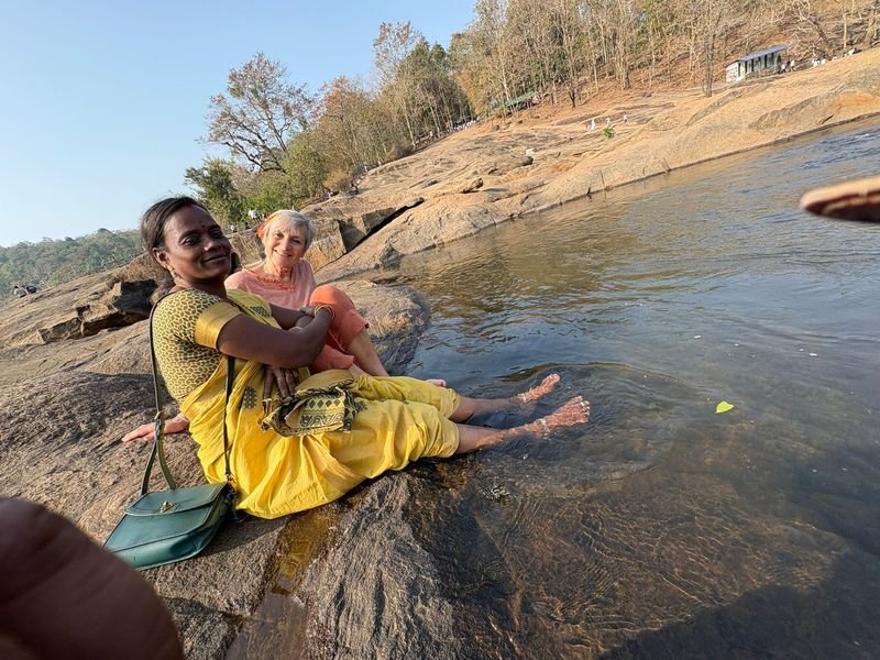 Foreign tourist posing near a river along with her companion