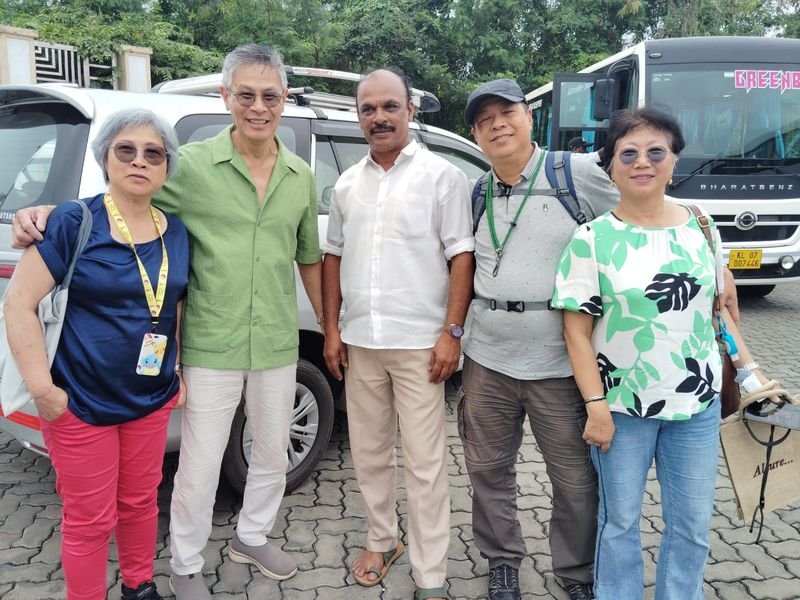 Group Photo Near cab and traveler bus