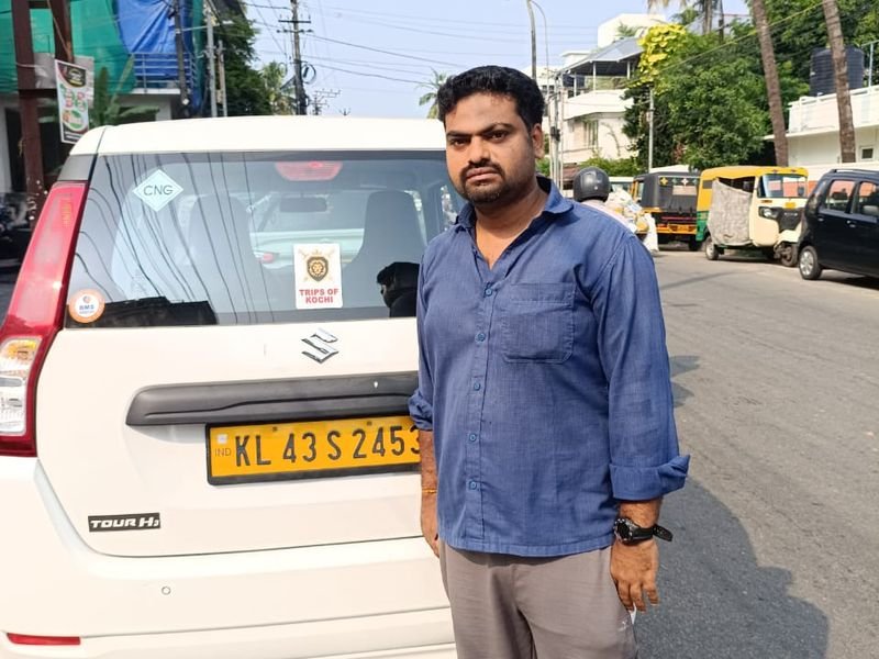 Posing with trips of Kochi Logo taxi