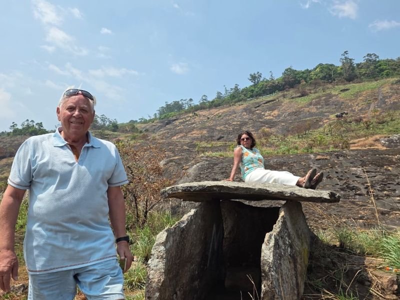 foreign tourists posing nearby a structure